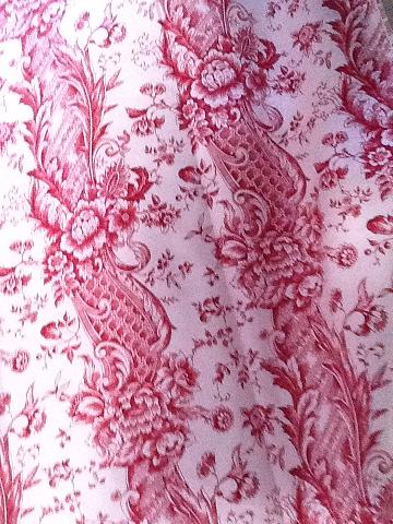 Piece of red toile de jouy fabric